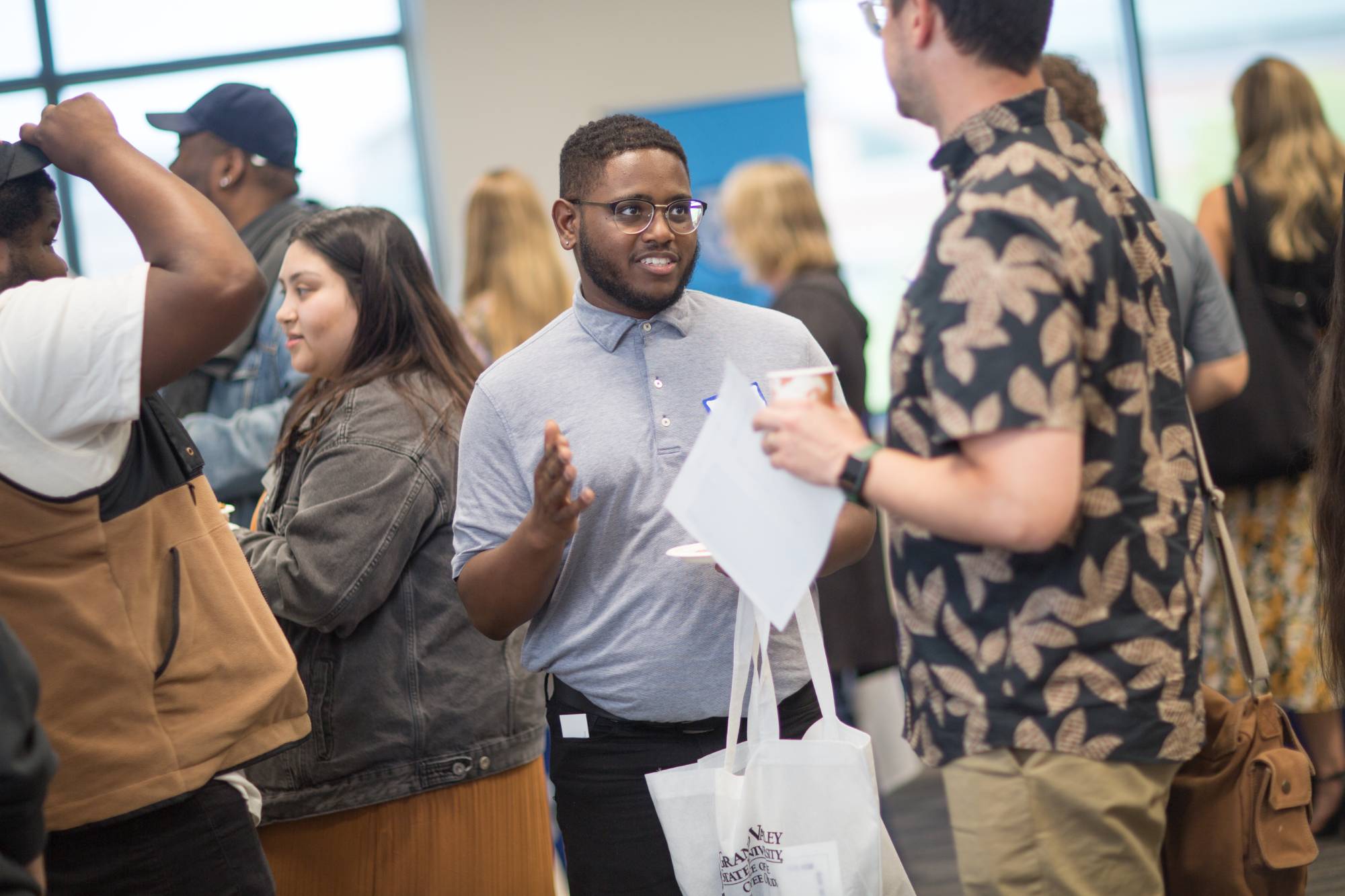 Two men standing and talking with each other